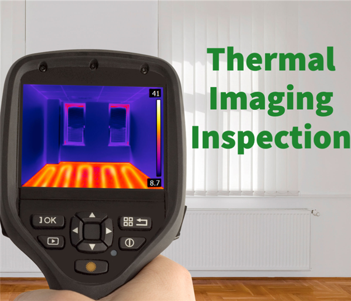Thermal imaging equipment being used to detect moisture damage in a property