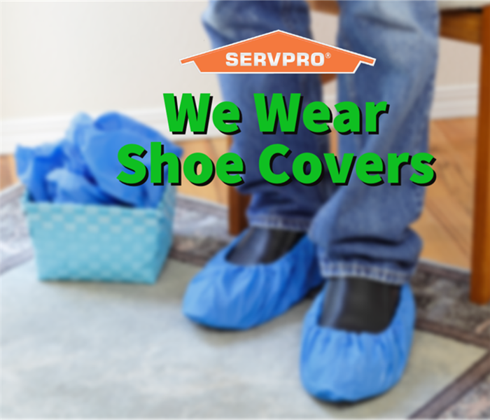 A SERVPRO employee in shoe covers